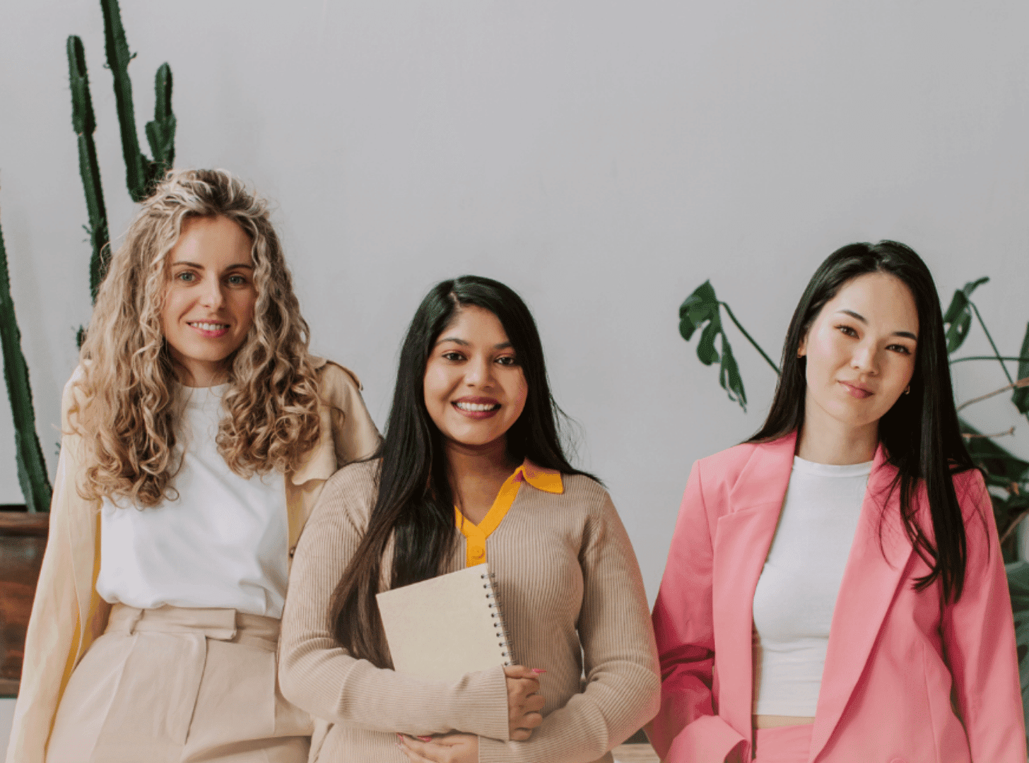 Three women in stylish outfits posing for the Live and Lead event.