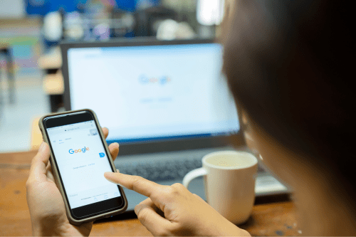 Close-up of a person on a smartphone searching Google, hide your address on Google My Business